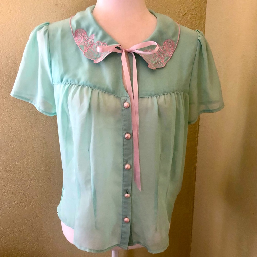 Pink and sea foam green mermaid shirt size medium excellent used condition.
